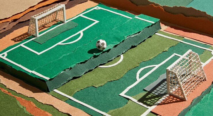 Tampilan data pasaran pertandingan sepak bola pada layar ponsel di atas meja